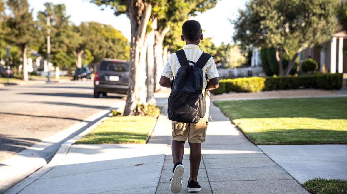 Safe Routes To School image of child wearing a backpack walking to school